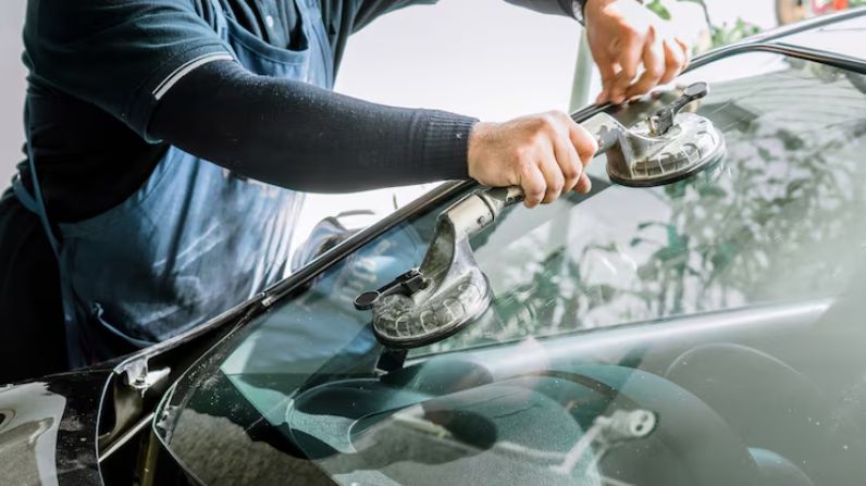 Technician performing windscreen repair in Brighton with services in Crawley, Horsham, and Worthing